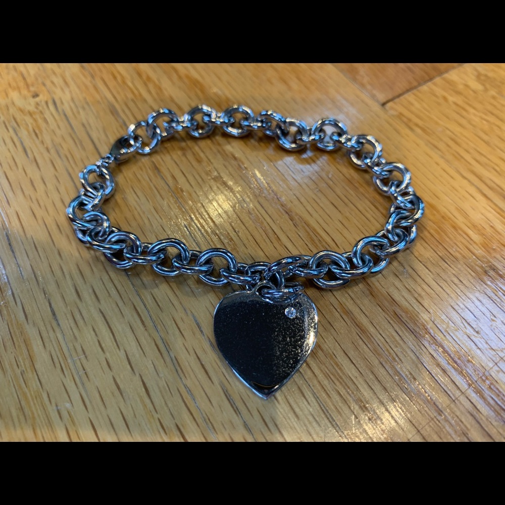 Silver heart charm bracelet with diamond.